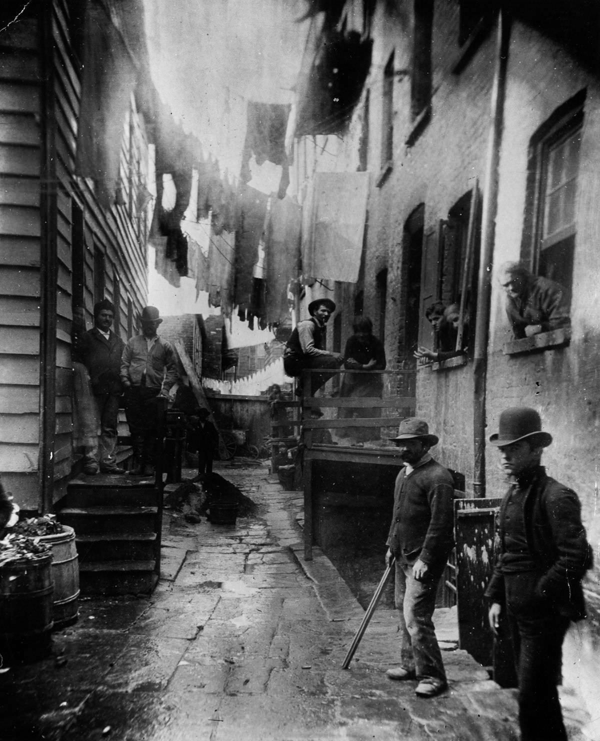 #4 A group of men loiter in an alley off Mulberry Street known as “Bandits’ Roost.” 1888