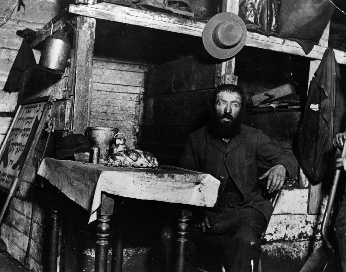 #5 A Jewish cobbler ready for Sabbath Eve in a coal cellar where he lives with his family, 1887