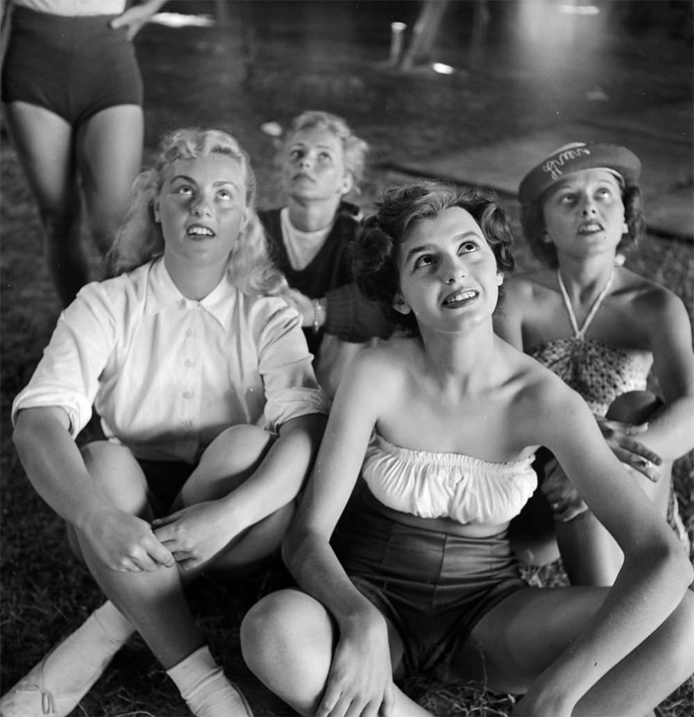 A picture of a group of circus girls sitting at a rehearsal for the Ringling Bros. and Barnum &; Bailey Circus in Sarasota, FL in 1949.