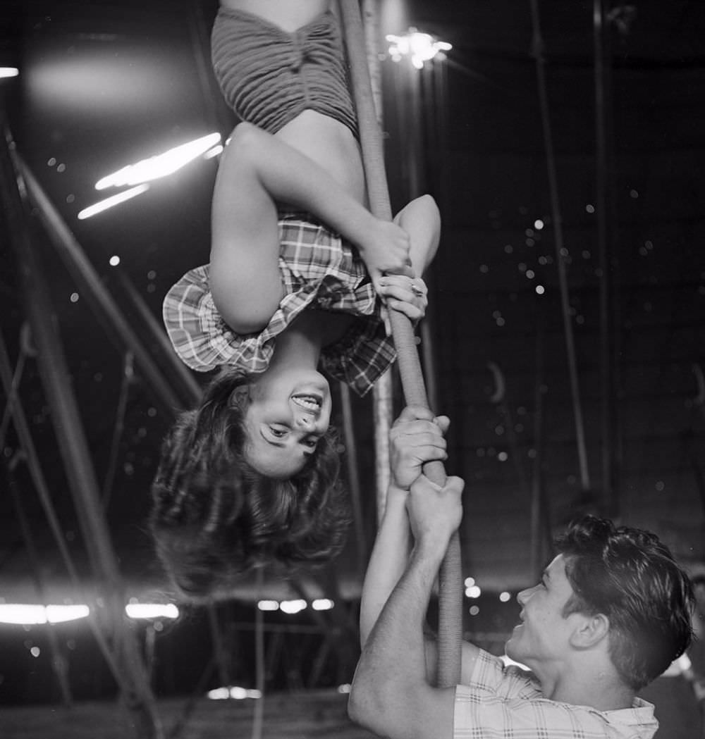 An acrobat rehearsing for the Ringling Bros. and Barnum &; Bailey Circus while an unidentified man holding a rope in Sarasota in 1949.