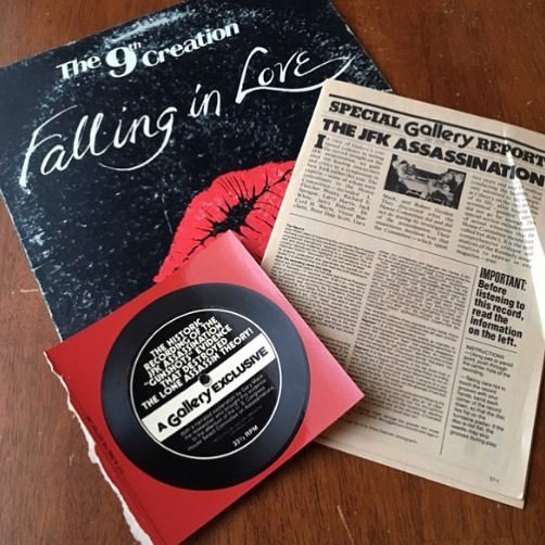 #38 A JFK assassination cardboard cutout record with a clipping of an article on the same subject found inside a copy of “Falling In Love” by The 9th Creation.