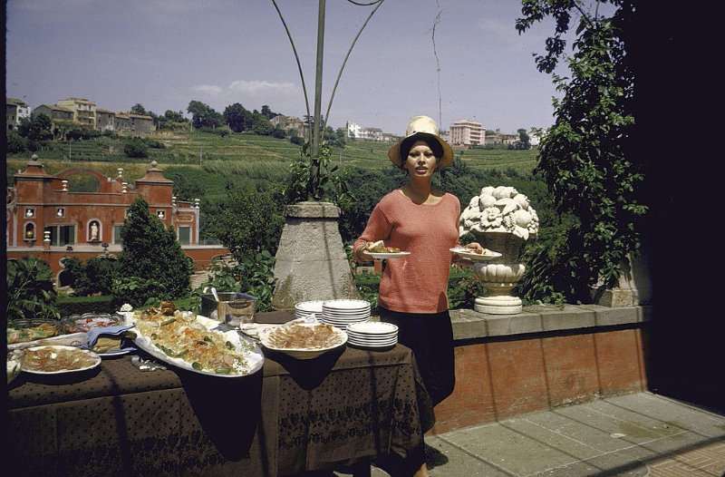 #24 Sophia Loren having lunch on a second floor terrace of her villa.