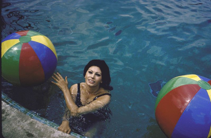 #6 Sophia Loren in the pool with colorful beach balls.