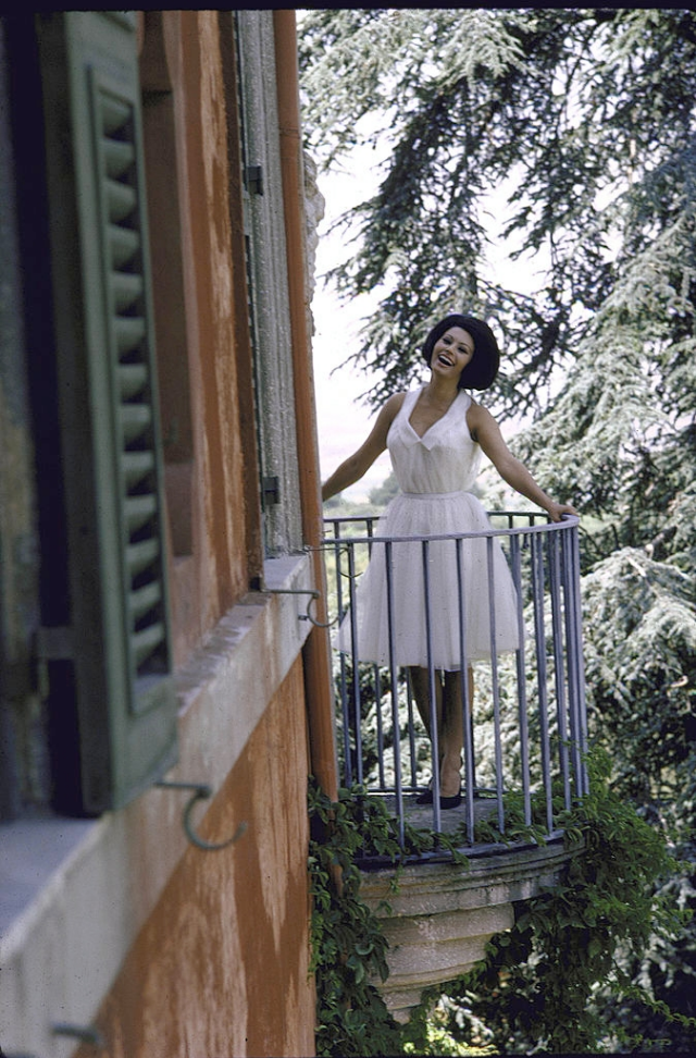 #30 Sophia Loren standing on a balcony at the villa.