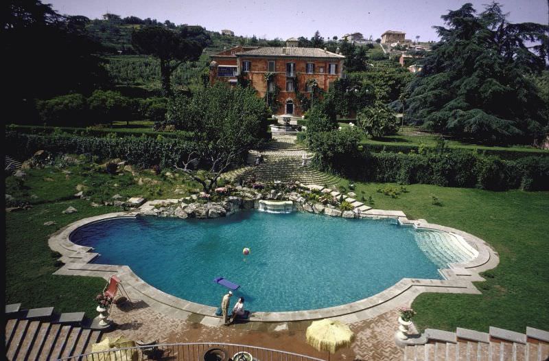 #11 Sophia Loren and Carlo Ponti on the edge of their 135-foot swimming pool.