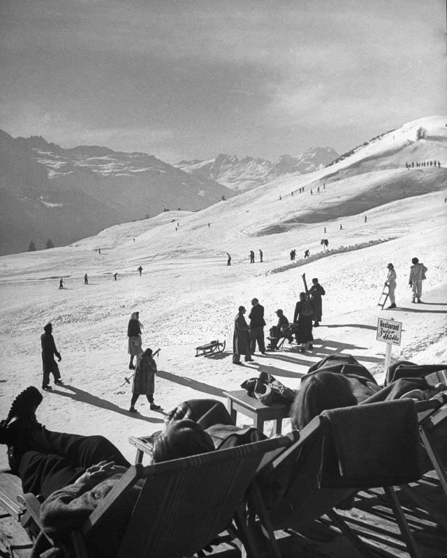 #21 Beginners and avid skiers taking to the slopes, while others are enjoying a lounge chair for watching the activities.