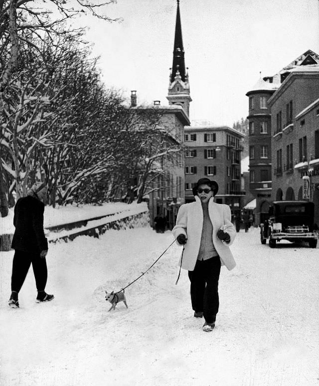 #4 Woman walking pet chihuahua in snow-covered winter-resort village.