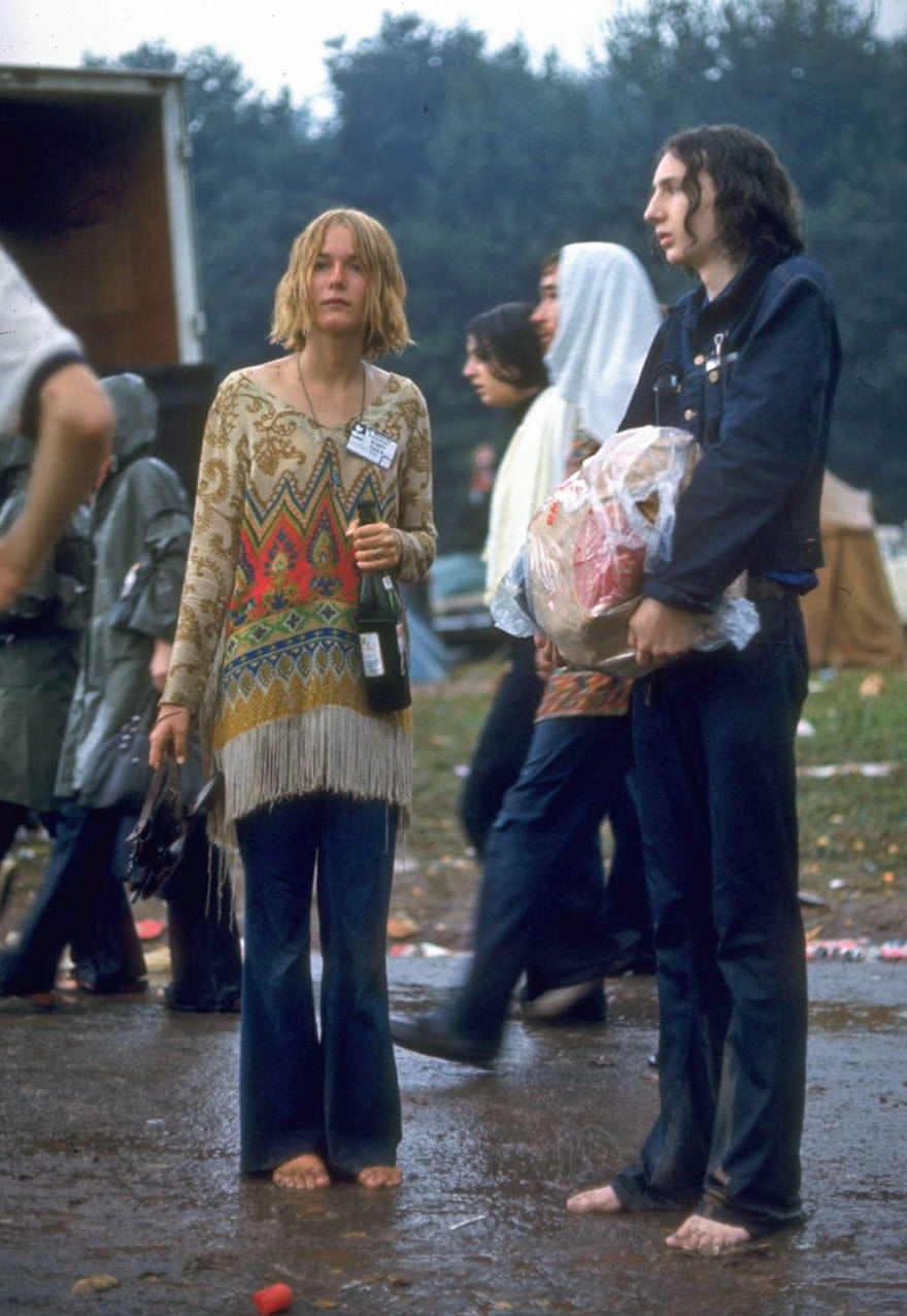#25 Hippie Couple Standing Barefoot On A Road Holding A Bundle & Wine Bottle At Woodstock