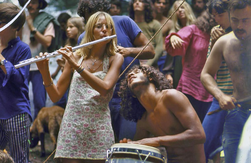 #21 Shirtless Male Drummer & Dress-Wearing Female Flutist Jamming During Woodstock Music Festival