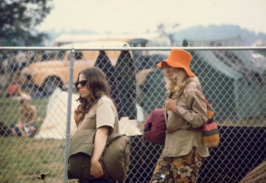#46 Two Young Women Walking Along The Fence With Sleeping Bags At The Woodstock Music Festival