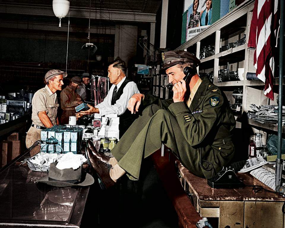 #102 While his father chats with a customer at the hardware store, a uniformed Jimmy Stewart sets up a date to go fishing,1945