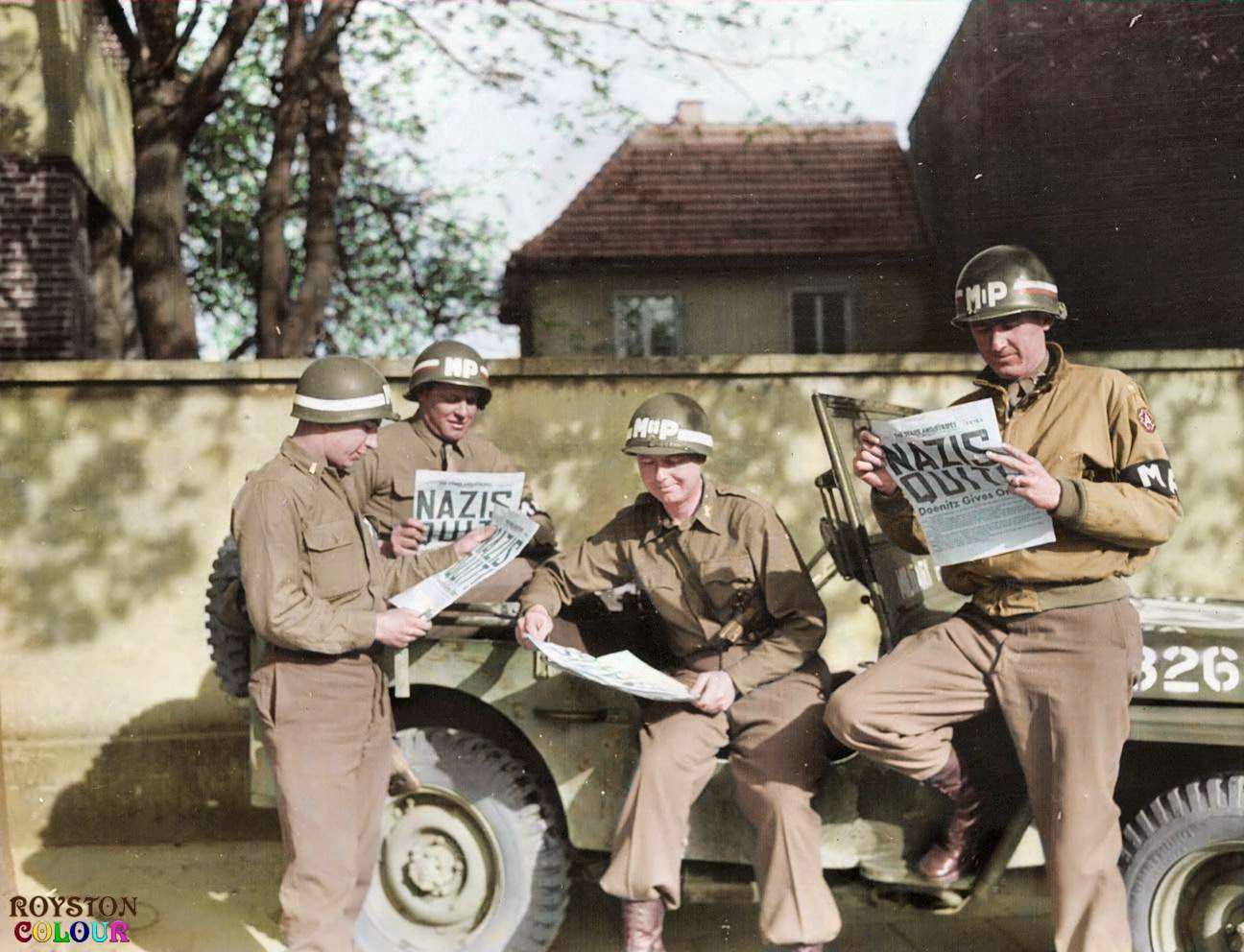 #107 9th Army MPs reading of the surrender in the ‘Stars and Stripes’ in Germany on the 8th of May 1945