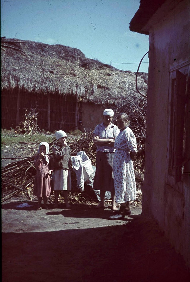 #122 Women with children in a courtyard in one of the occupied village of the Belgorod region, Russia, 1943