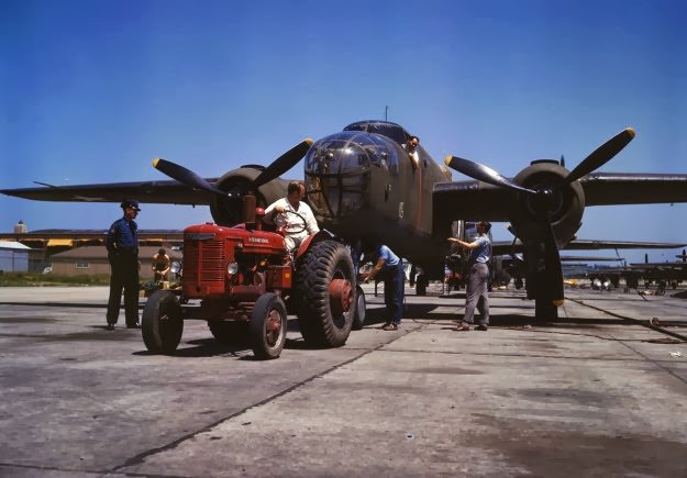 #162 B-25 bomber planes at the North American Aviation, Inc., being hauled along an outdoor assembly line with an “International” tractor, in Kansas City, Kansas, in October, 1942