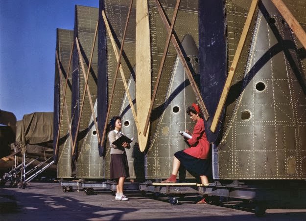 #181 Carefully trained women inspectors check and inspect cargo transport innerwings before they are assembled on the fuselage, at Douglas Aircraft Company in Long Beach, California, in October of 1942