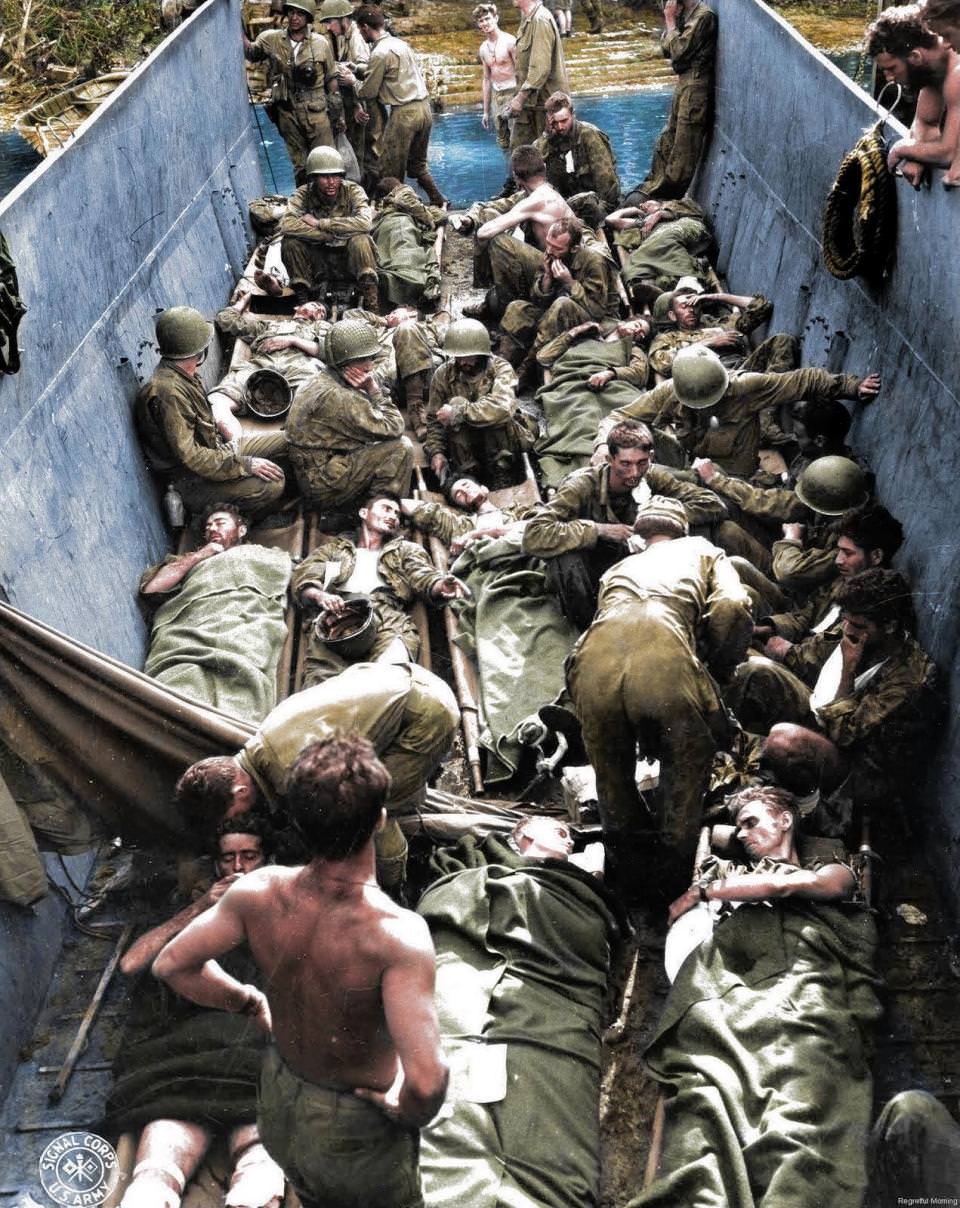 #21 Wounded troops lying on stretchers aboard a lighter in Munda Point, New Georgia. There were more than 36 million casualties during the War in the Pacific.