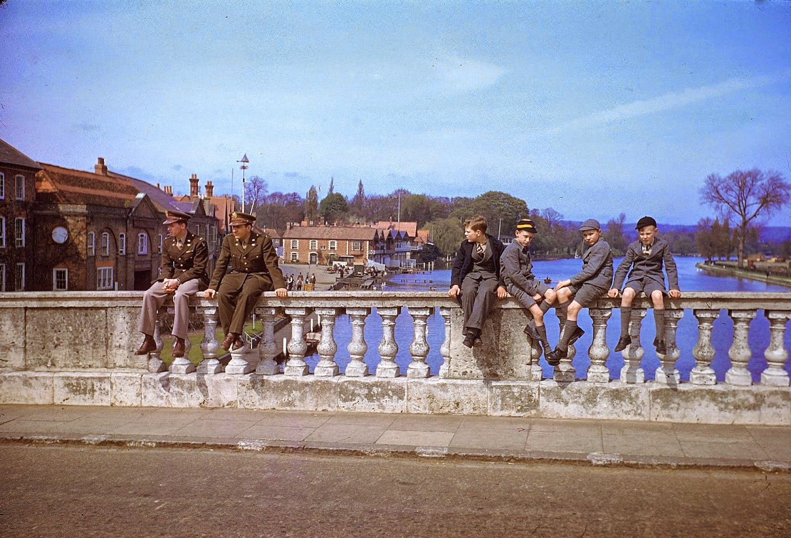 #6 A pair of servicemen and a quartet of schoolboys sit on bridge over the Thames, Henley-on-Thames, England, May 1944.