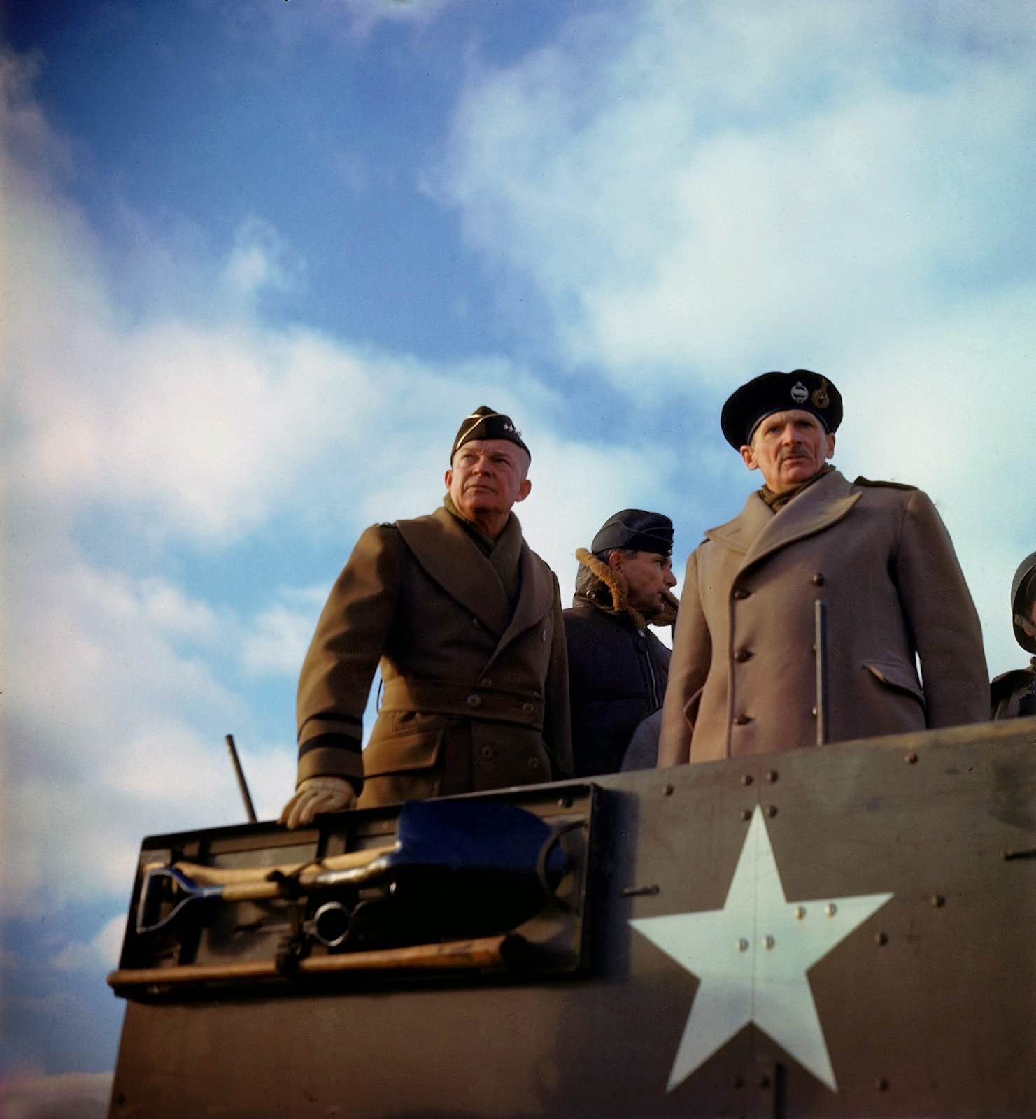 #7 Supreme Allied Commander American General Dwight D. Eisenhower, his deputy, British Chief Air Marshal Arthur Tedder , and the principal commander of Allied ground forces in Europe, British General Bernard L. Montgomery, stand in a US armored vehicle as they review a tank exercise, Salisbury, England