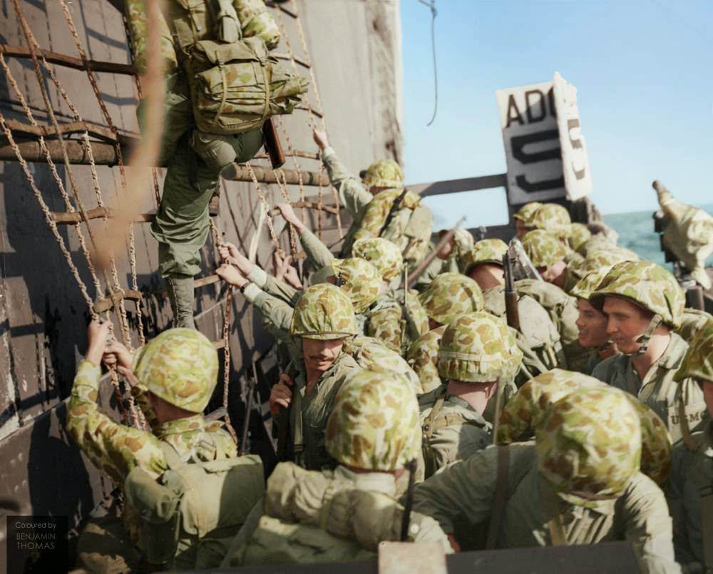 #80 United States Marines climbing down the nets into landing craft during the Battle of Peleliu, September-November 1944.