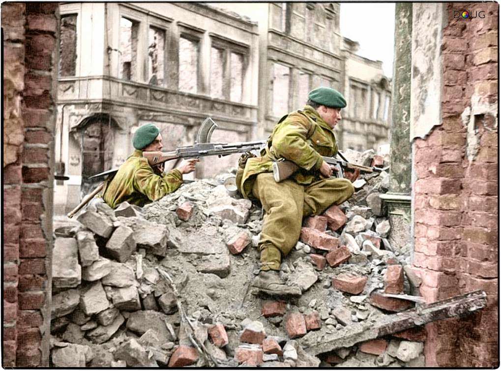 #87 Royal Marines from 45 (RM) Commando, 1st Commando Brigade on the look-out for snipers among the ruins in Osnabrück, Lower Saxony, Germany. 4th of April 1945