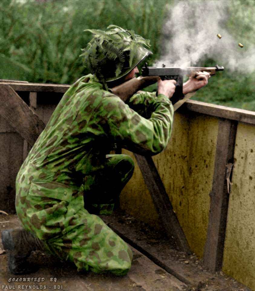 #93 A US Marine wearing his camouflage suit fires a Thompson sub-machine gun during Jungle Training – 1942