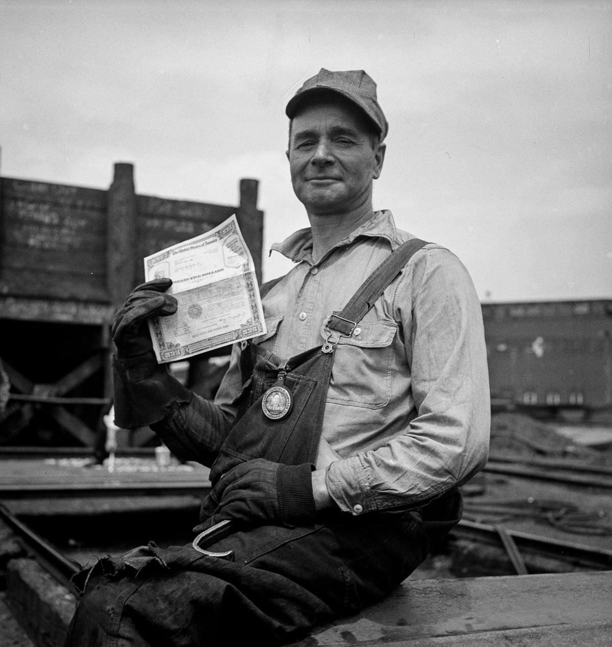 #21 A shipyard worker shows off a war bond