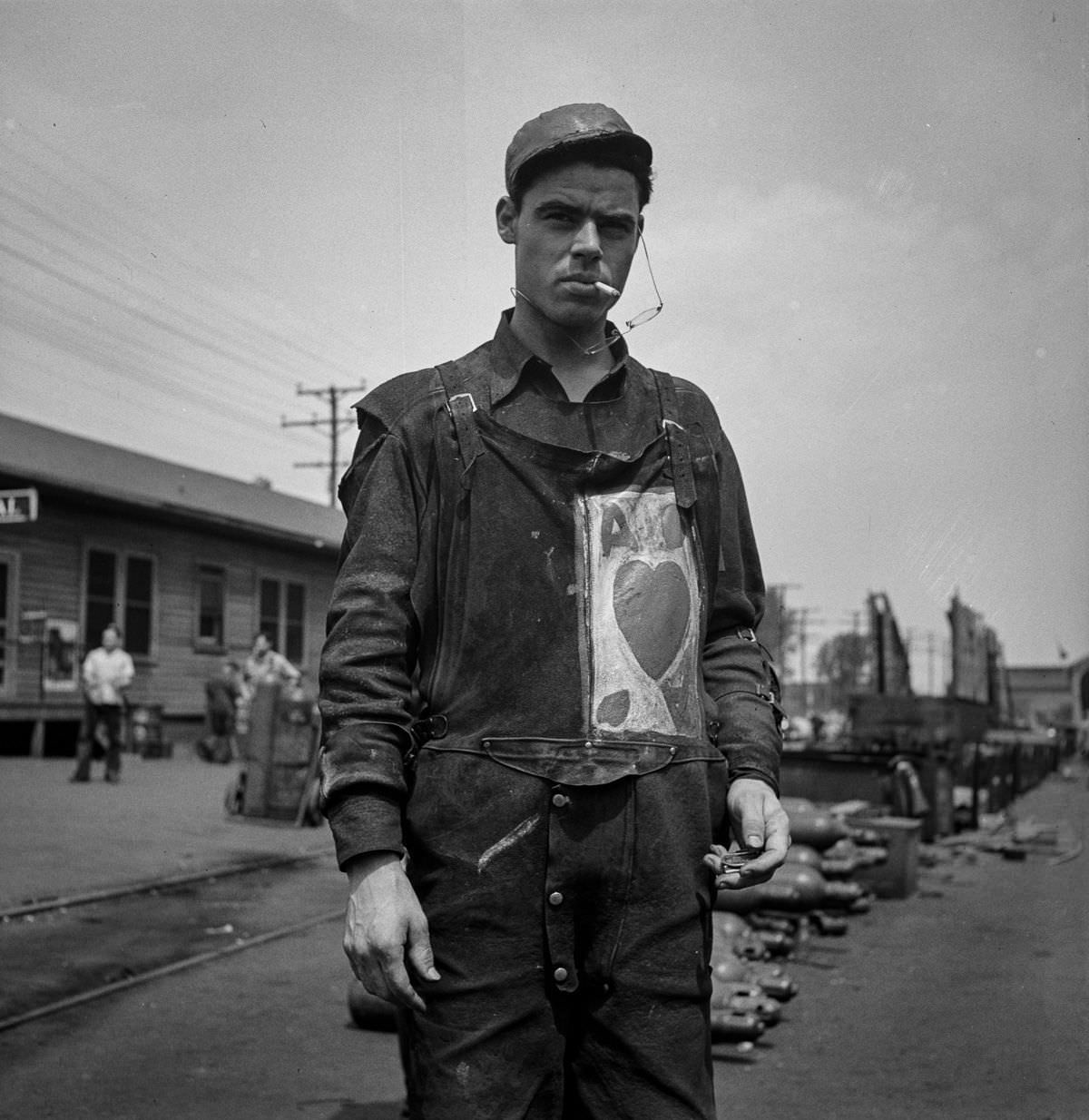 #29 A worker with a personal monogram on his overalls