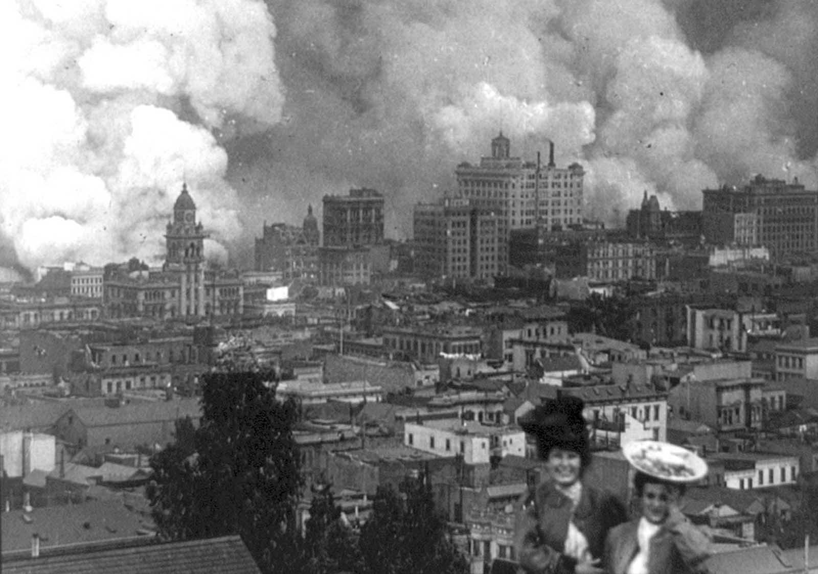 #31 Onlookers pose for a photograph as San Francisco burns in the background on April 18, 1906.
