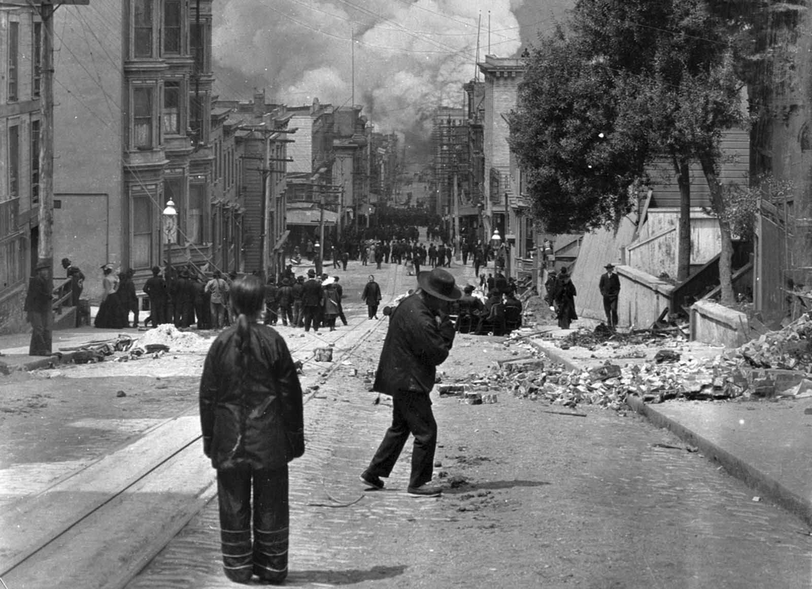 #2 San Francisco residents stand in the rubble-strewn streets watching the fire grow after the earthquake struck on April 18, 1906.