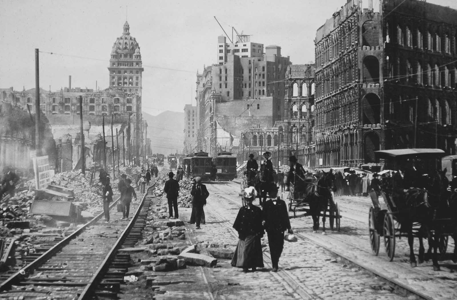 #52 Market Street, looking west toward the Twin Peaks, from Battery Street. Both sides of Market Street lined with ruined buildings from Battery to Powell.