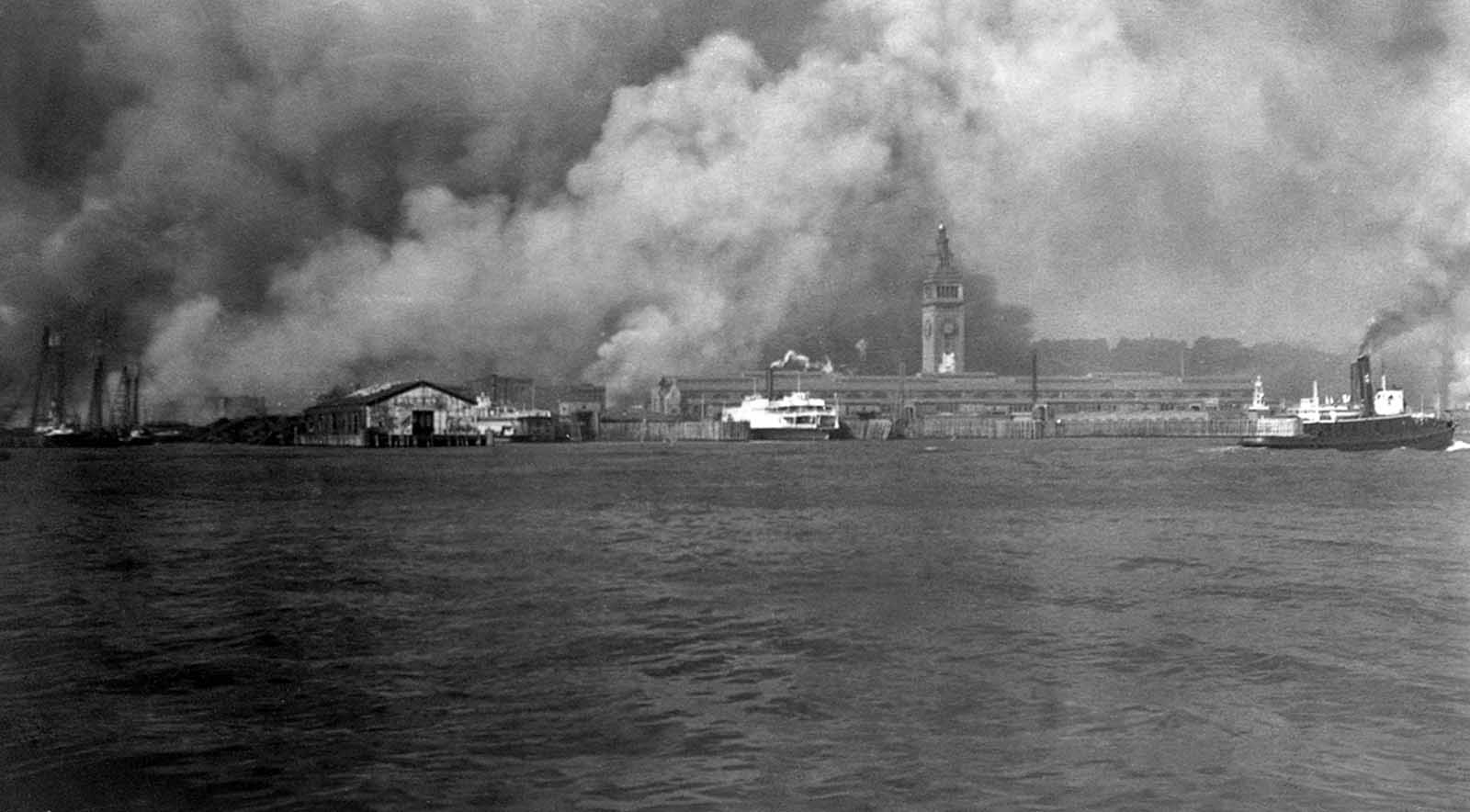 #27 Smoke rises from burning buildings on the waterfront during the fire after the earthquake of 1906 in San Francisco, California.