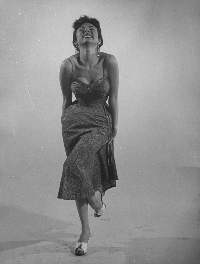 #9 Rita Moreno imitating the sexy-wild actress by raising one leg in her tight and sexy semi-revealing dress, 1954.