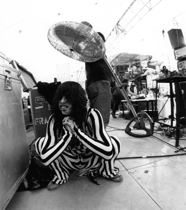 Aerosmith lead singer, Steven Tyler, cools himself off backstage after a performance at the RFK Stadium in 1976