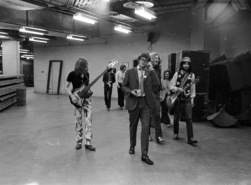 Led Zeppelin’s bassist, John Paul Jones, singer, Robert Plant, and guitarist, Jimmy Page, walk backstage at the Forum in Los Angeles in 1977