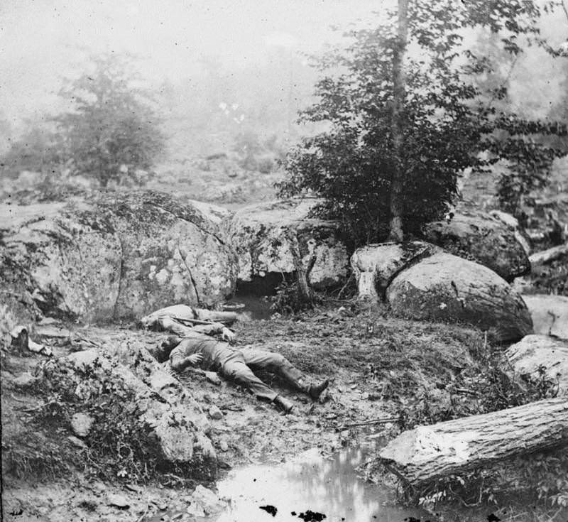 Dead Confederates lie in the area known as the “slaughter pen” near Little Round Top.