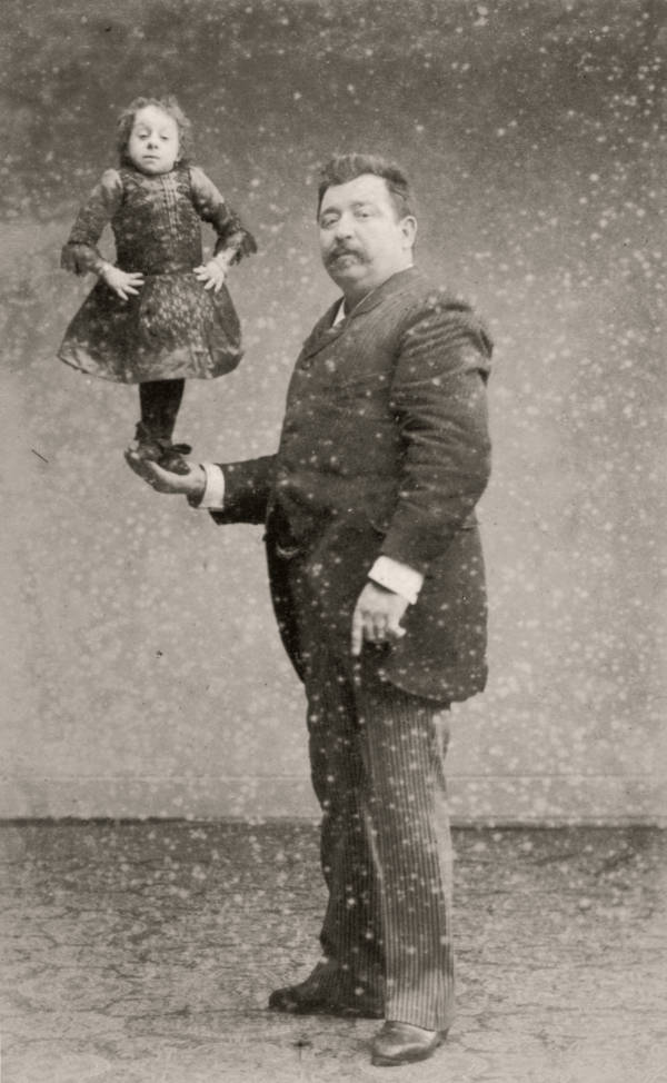 Dutch midget Johanna Pauline Musters, a.k.a. “Princess Pauline,” “Lady Dot” or the “Midget Mite,” standing on the hand of her manager Verschueren, 1890