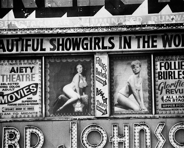 Posters advertising burlesque shows at the Follies Burlesk and Gaiety Theater in in Times Square, New York City, 1975.
