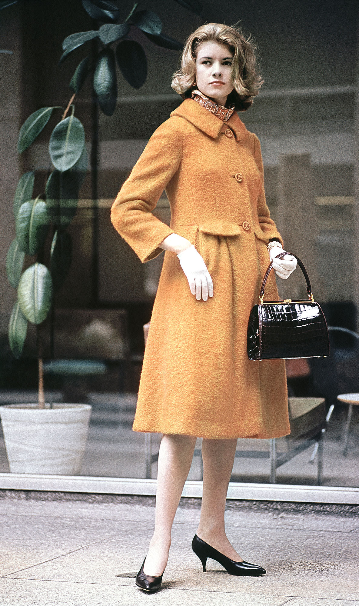 #8 Martha Stewart sitting sideways on a chair, 1970