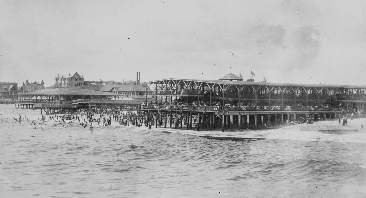 #13 The old wooden pavilion in Asbury Park to the right, 1901. The pavilion on the left was the Ocean Grove Rose pavilion