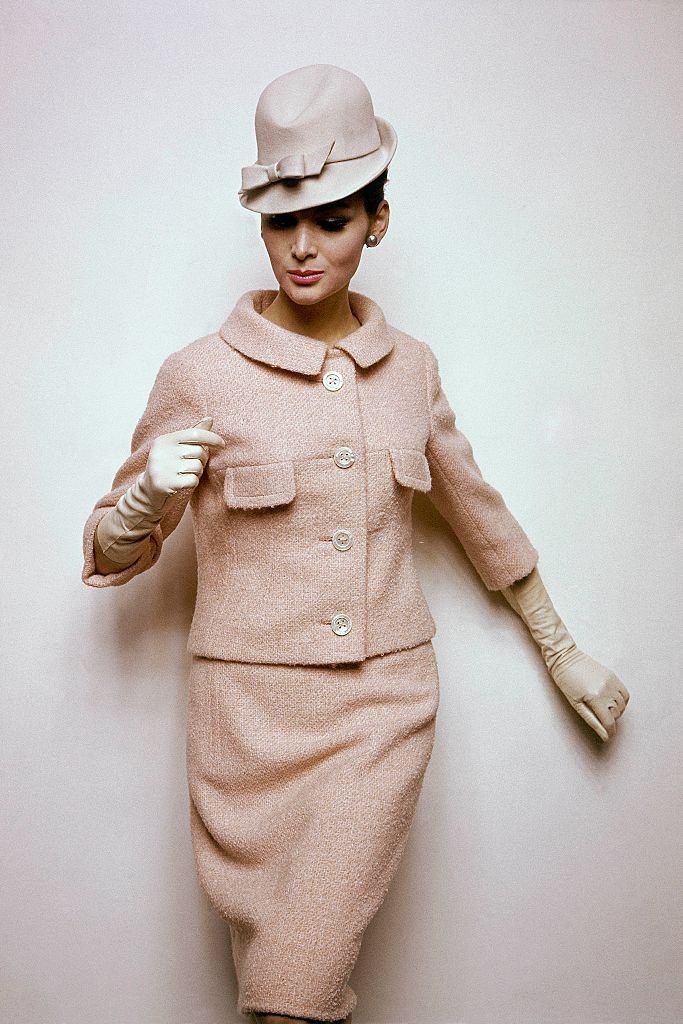 #28 Model wearing skirt suit in pale apricot boucle, Vogue 1963