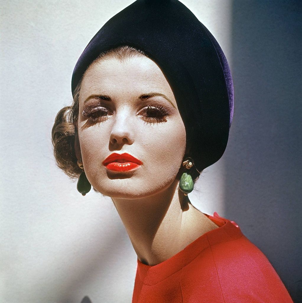 #5 Model Dorothea McGowan wearing curved velvet toque in deep purple, Vogue 1961