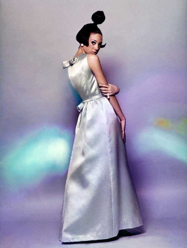 #54 Model Marisa Berenson wearing a long blue evening dress with a bell skirt, Vogue 1965