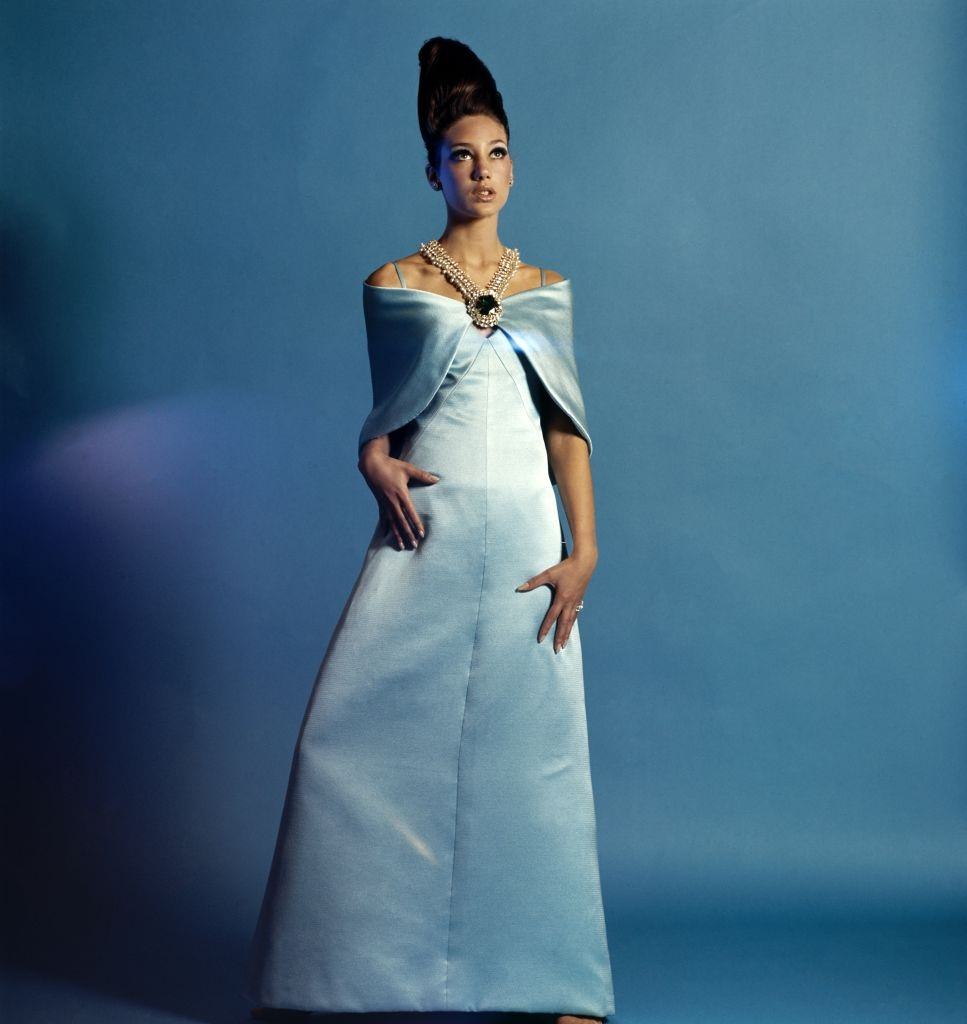 #58 Model Marisa Berenson in a Adele Simpson gown and shawl with Schreiner jewelry, Vogue 1965