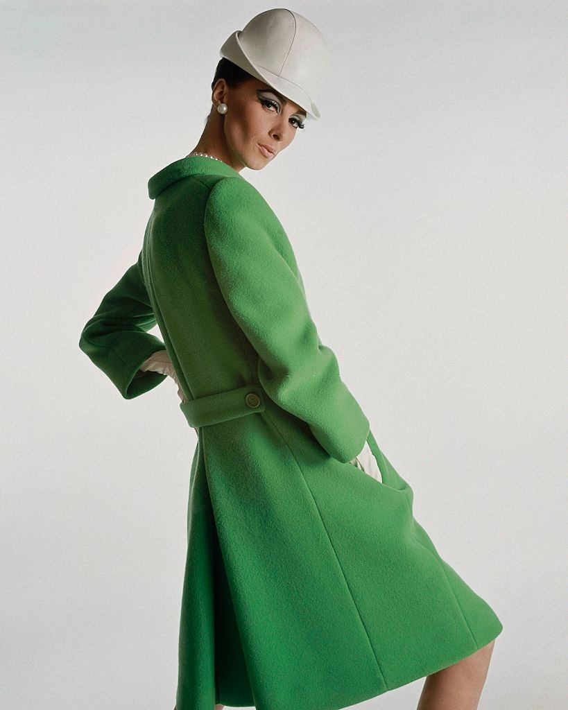 #62 Model wearing green wool belted coat, Vogue 1966