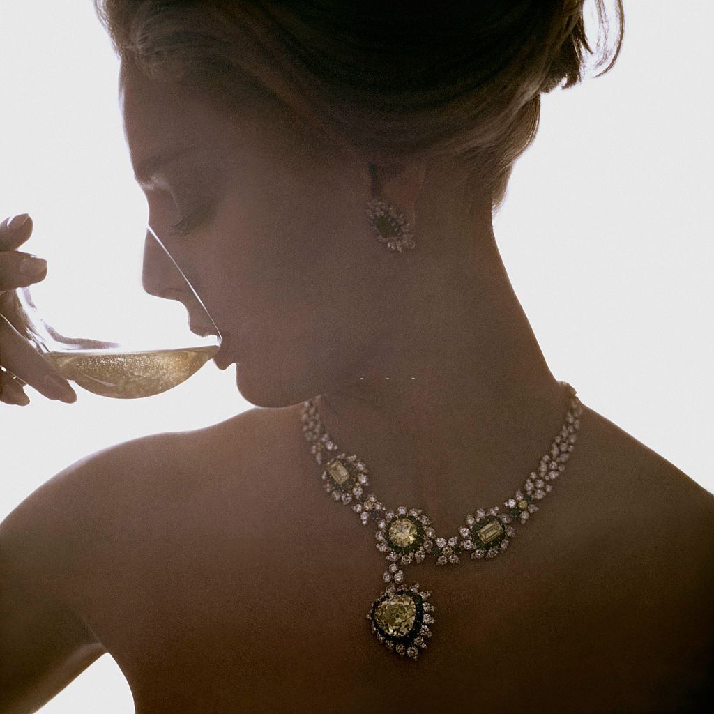#7 Model wearing a Van Cleef & Arpels necklace of canary diamonds, Vogue 1961