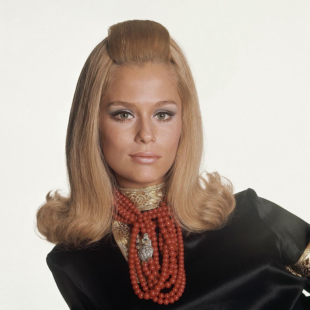 #74 Model Lauren Hutton wearing black satin cossack’s blouse by Lynn Stuart for Mister Pants, Vogue 1966