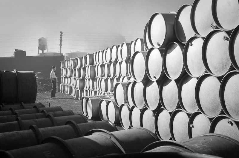 #23 A workman studies a massive drum farm at the Proctor and Gamble factory, July 15th, 1939