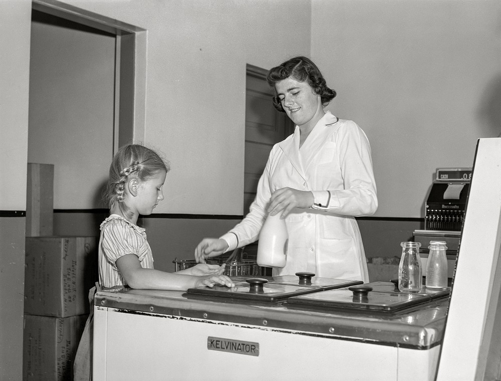 #13 Child buying bottle of milk from Duluth Milk Company, Duluth, Minnesota, August 1941