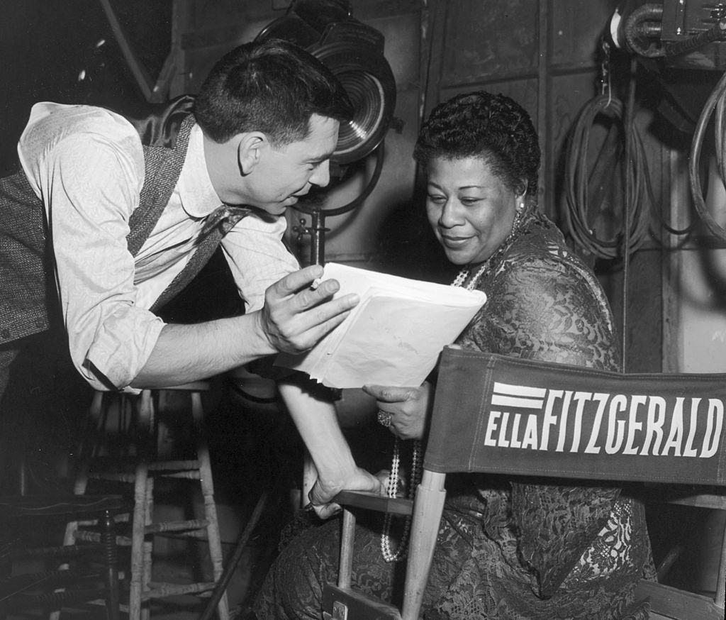 Ella Fitzgerald with Jack Webb discussing a script on the set of Webb’s film, ‘Pete Kelly’s Blues,’ in which Fitzgerald had a role, 1955