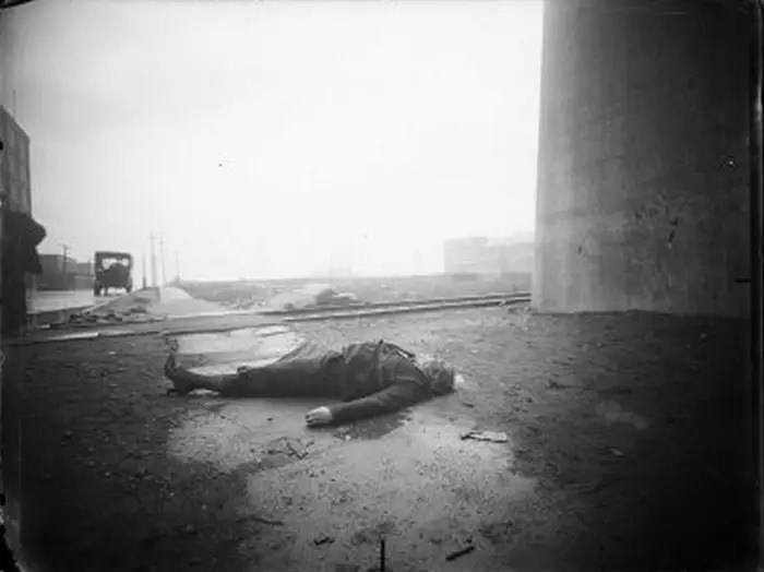 A woman’s body found in the Bronx next to a concrete structure. Trolley tracks can be seen in the background, June 24, 1917